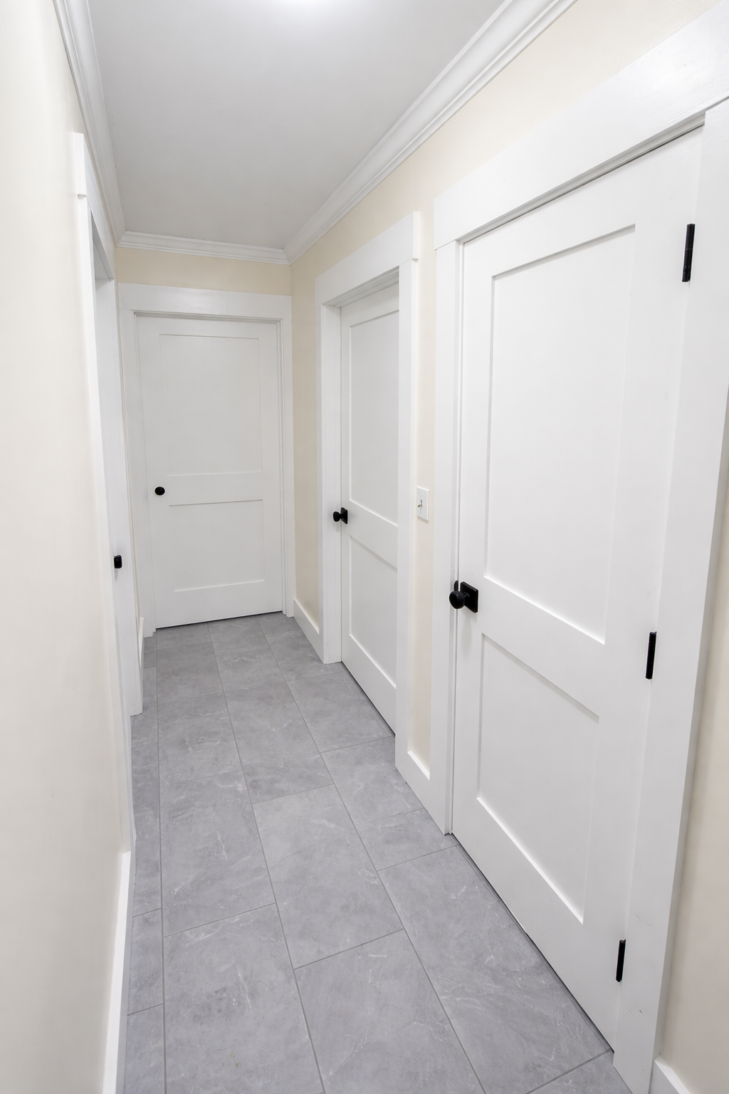 Angled hallway with white doors and trim